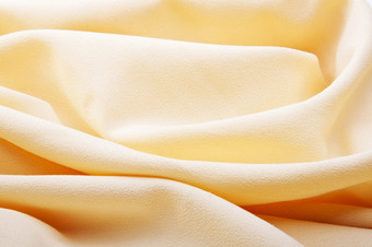 背景明亮的黄色的丝绸与波纹理背景明亮的黄色的丝绸与波