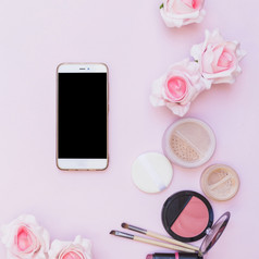 手机化妆品产品花粉红色的背景粉红色的背景