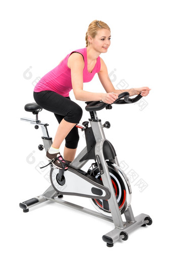 年轻的女人做室内骑自行车锻炼微调控制项<strong>运动</strong>模糊移动部分