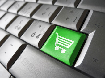 网络而且互联网行购物概念与篮子图标而且象征绿色移动PC电脑关键为网站而且在线业务