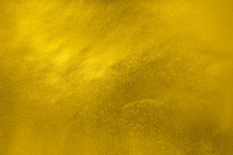 明亮的闪亮的黄色的黄金纸背景纹理