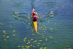 两个年轻的运动员划船团队绿松石绿色湖