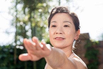 快乐的中老年女士在户外练瑜伽伸展写实拍摄