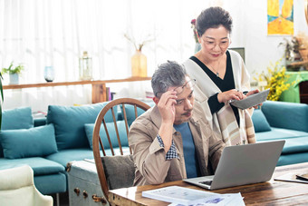 中老年夫妇在家使用笔记本电脑