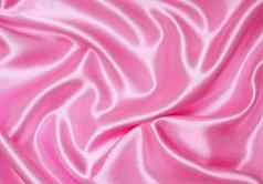 光滑的优雅的粉红色的丝绸背景