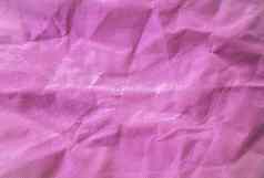 特写镜头空粉红色的crumled织物皱纹背景