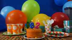生日蛋糕乡村木表格背景色彩斑斓的气球礼物塑料杯塑料板糖果蓝色的墙背景