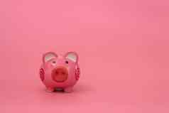 粉红色的小猪银行柔和的粉红色的背景金融概念