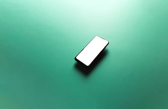 简约模拟平图像设计浮动移动电话复制空间白色小石子写平绿色背景