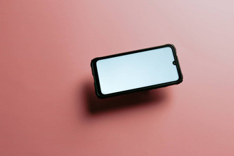 简约模拟平图像设计移动电话复制空间白色小石子写平柔和的粉红色的背景