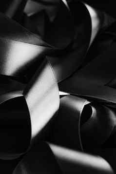 黑色的白色丝绸丝带背景摘要奢侈品