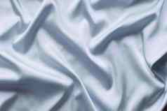 光滑的优雅的蓝色的丝绸软折叠背景