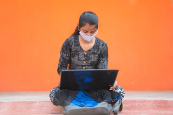 年轻的女孩学生医疗面具忙工作移动PC考勒格走廊大学校园概念大学重开正常的由于冠状病毒科维德流感大流行