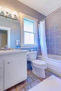 蓝色的浴室白色橱柜石头瓷砖蓝色的瓷砖