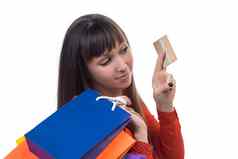 年轻的女人购物信贷卡持有色彩鲜艳的纸