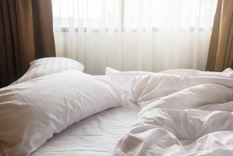 白色枕头毯子皱纹混乱的床上卧室