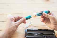 男人。准备胰岛素糖尿病注射器注射人糖尿病健康护理概念