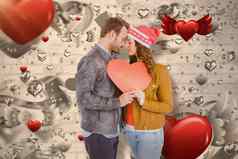复合图像浪漫的年轻的夫妇持有心形状纸