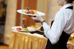 女服务员携带盘子肉菜