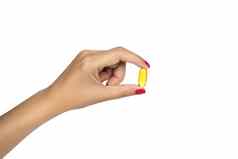 维生素补充健康的概念特写镜头女人手持有黄色的鱼石油药丸孤立的白色背景健康的吃饮食营养高决议图像空间文本