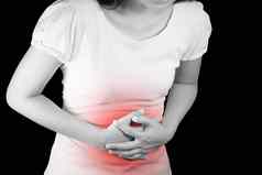 女人遭受胃痛胃肠病学概念医疗保健医学疼痛红色的颜色隔离黑色的背景剪裁路径