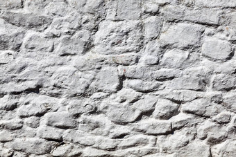 灰色白色饱经风霜的粗糙的石头<strong>墙</strong>纹理
