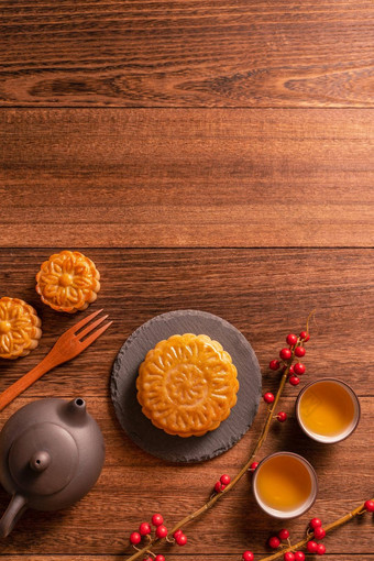 月亮蛋糕月饼表格设置中国人传统的糕点茶杯木背景中秋节日概念前视图平躺