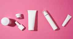指甲波兰的Jar空白色塑料管化妆品粉红色的背景包装奶油过来这里血清广告产品促销活动