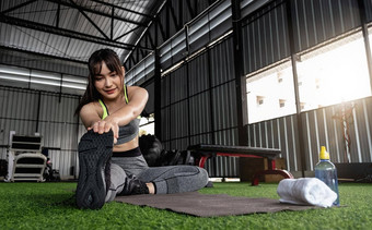 年轻的亚洲女时尚的舒服的运动服装伸展运动腿健身地板上锻炼体育运动概念适合女人伸展运动锻炼健身房