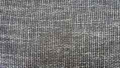 特写镜头灰色的织物纹理背景壁纸纹理织物灰色的纺织室内装潢灰色的斜纹软呢纹理灰色的羊毛模式
