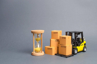 黄色的叉车卡车纸板盒子沙子沙漏表达交付概念优化物流交付改善效率临时存储有限的提供折扣