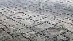 混凝土鹅卵石灰色的铺平道路板石头地板上人行道上城市大灰色的铺平道路瓷砖关闭