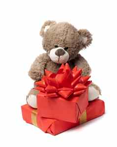 可爱的棕色（的）泰迪熊盒子包装纸红色的丝绸丝带白色背景奖祝贺你