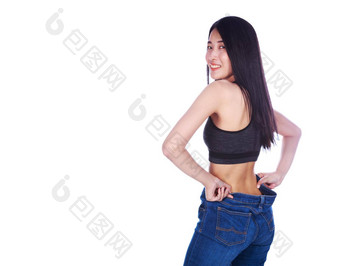 女人显示重量损失穿牛仔裤孤立的白色背景