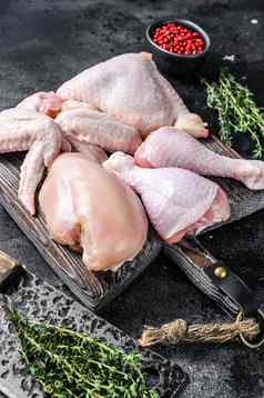 新鲜的生鸡肉翅膀乳房大腿鸡腿黑色的背景前视图