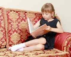 女孩坐着沙发上阅读书