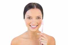 微笑女人持有牙齿刷