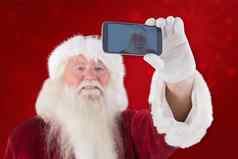 复合图像圣诞老人采取自拍电话
