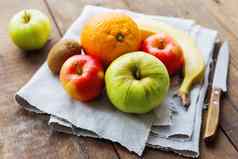 健康的零食背景红色的绿色苹果橙色香蕉猕猴桃乡村木背景