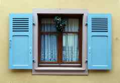 窗口蓝色的木百叶窗米色墙圣诞节装饰