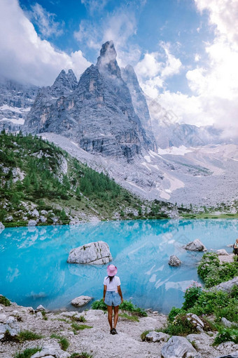 女人徒步旅行蓝色的绿色湖意大利白云石山脉美丽的湖索拉皮斯泻湖索拉皮斯白云石山脉受欢迎的旅行目的地意大利