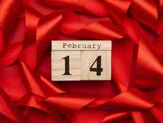 木日历日期2月红色的背景扭曲的红色的丝绸丝带