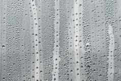 摘要背景点缀水滴雨滴玻璃多雨的天气闪闪发光的闪亮的表面水玻璃水滴形式球球体灰色雨滴