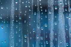 雨滴玻璃多雨的天气闪闪发光的闪亮的表面水玻璃水滴形式球球体蓝色的雨滴背景摘要背景点缀水