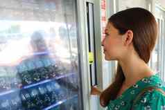 年轻的女背包客旅游选择零食喝自动售货机威尼斯意大利自动售货机女孩