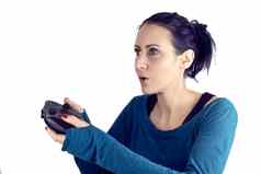 年轻的女人蓝色的毛衣红色的指甲波兰的玩视频游戏无线游戏控制器集中面部表达式孤立的白色背景