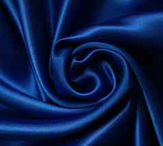 光滑的优雅的黑暗蓝色的丝绸背景