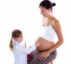 美丽的怀孕了女人和孩子女孩听诊器医生