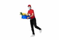 亚洲交付男人。穿脸面具红色的统一的持有新鲜的食物篮子孤立的白色背景表达交付服务科维德