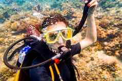 女人假期潜水潜水热带珊瑚礁